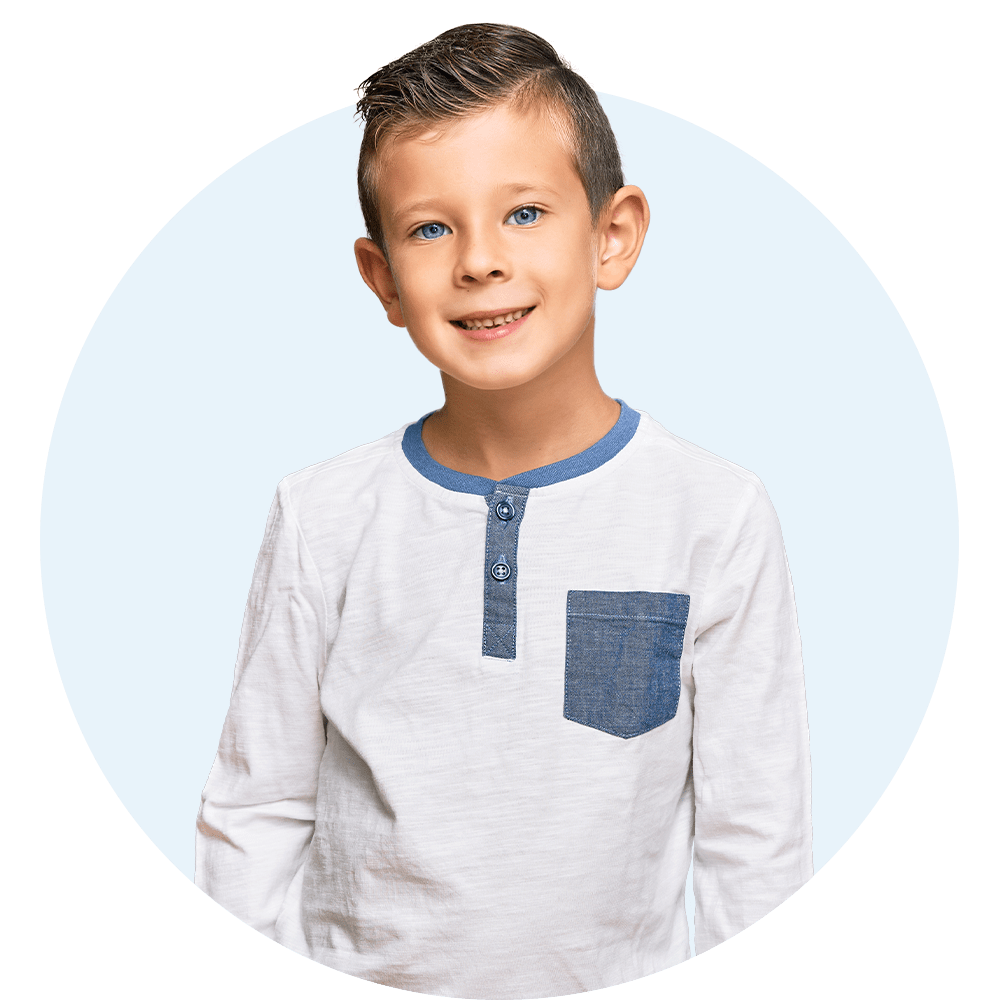 Young boy with blue eyes smiling at the camera.