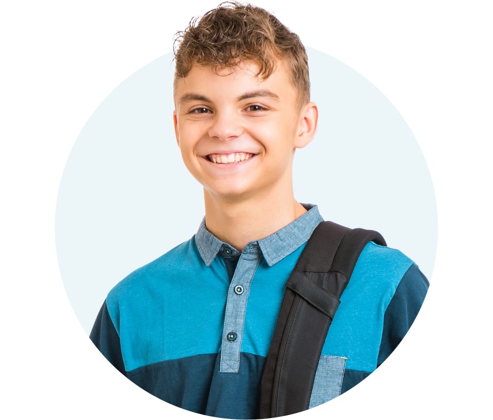 Teenage boy wearing a blue shirt and a backpack, smiling at the camera.