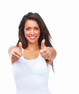 Happy young girl showing thumbs up sign isolated on white backgr