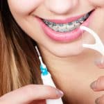 Flossing with Braces and Why It’s Important - Cory Liss Orthodontics - Orthodontists in Calgary