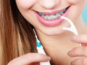 Flossing with Braces and Why It’s Important - Cory Liss Orthodontics - Orthodontists in Calgary